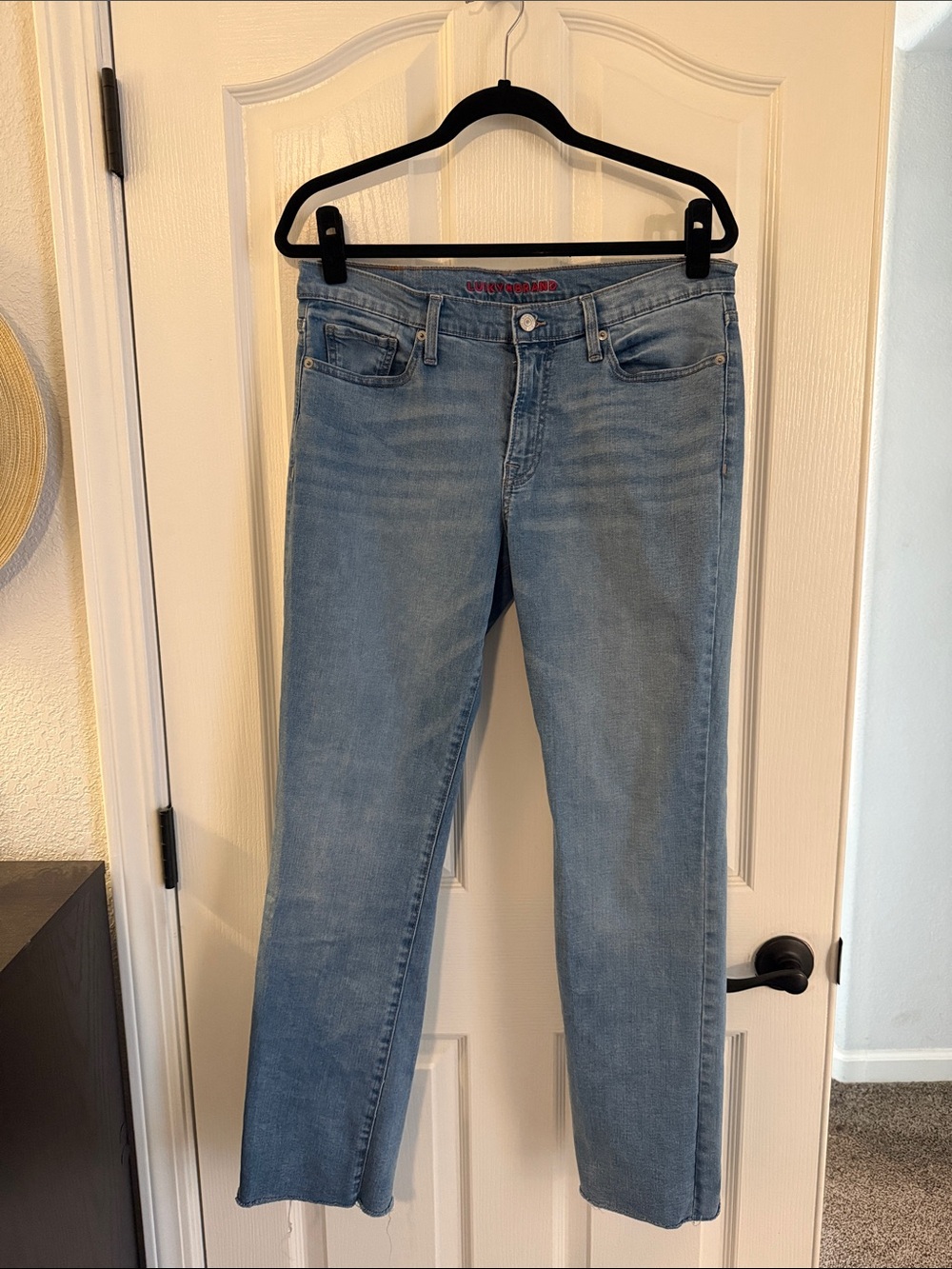 Lucky mid rise straight jeans with raw edges.